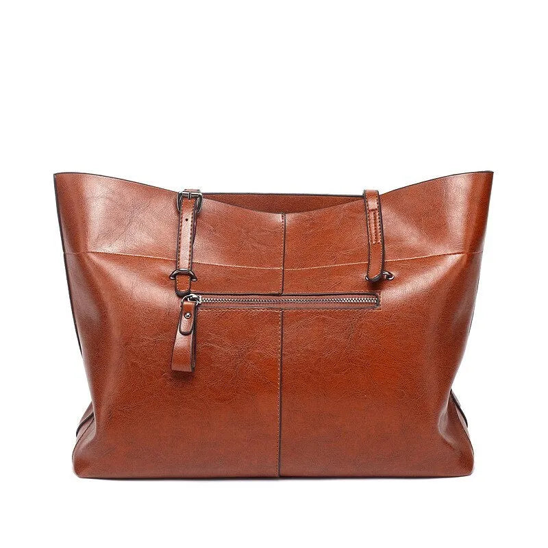Brown waxed cowhide leather women's crossbody handbag with a structured shape and a front flap.