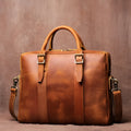 Men's large brown cow leather vintage handbag with zip closure, handle, shoulder strap, and 15 inch laptop space