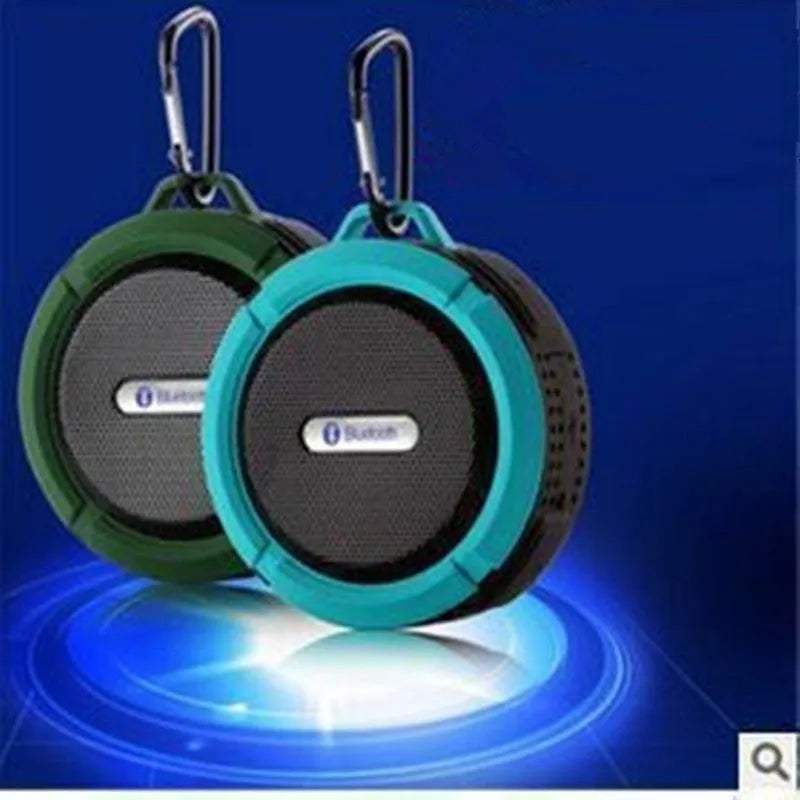 Compact waterproof Bluetooth speaker with a mounting clip, shown in blue.