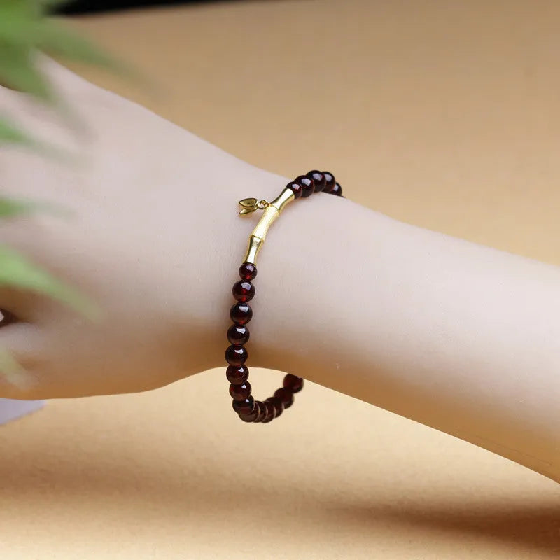 Handmade natural garnet bracelet with a 6mm silver or copper bamboo joint centrepiece.