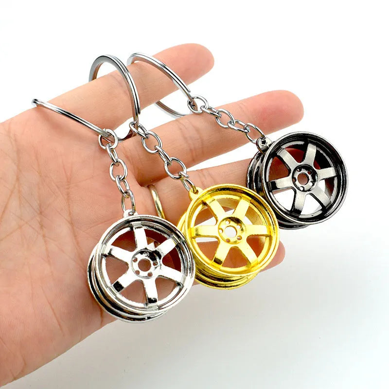 Stereo car wheel hub keychain in zinc alloy with gold, silver, and black colour options