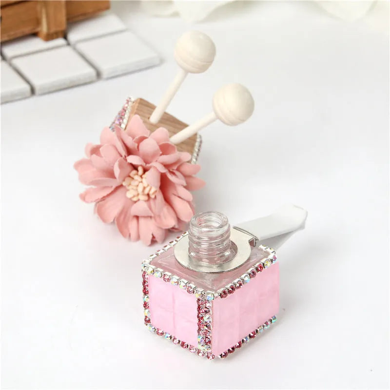 Car flower outlet perfume air freshener in white colour clipped to vehicle air vent, 3.2cm x 7cm size