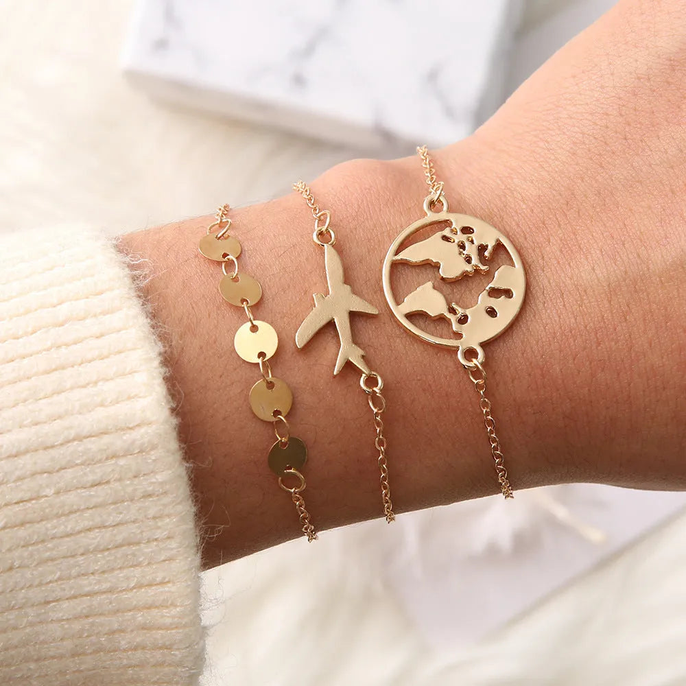 Three silver Bohemian bracelets with heart-shaped charms showing aircraft map details