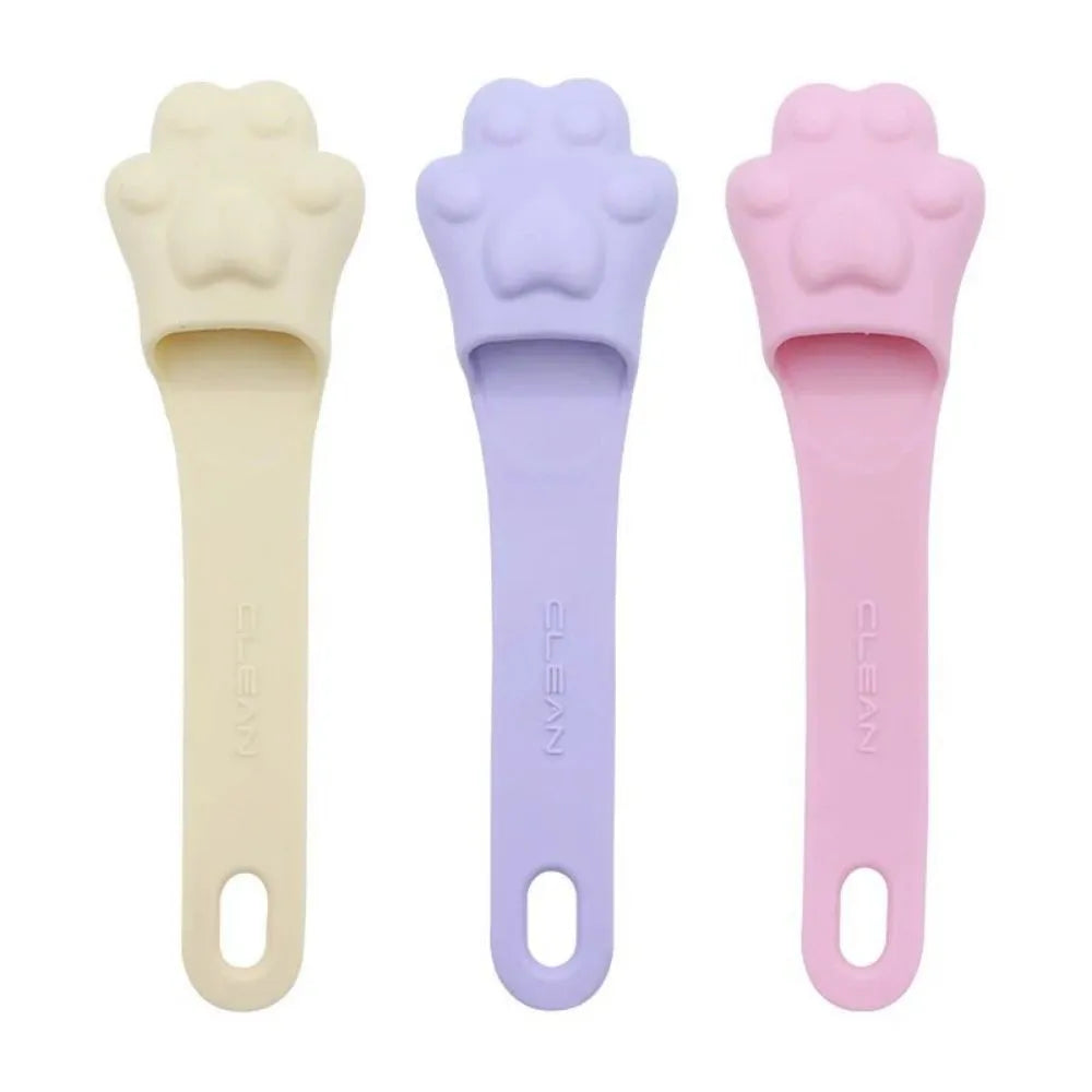 Silicone finger toothbrush for pets in pink, purple, and yellow colours
