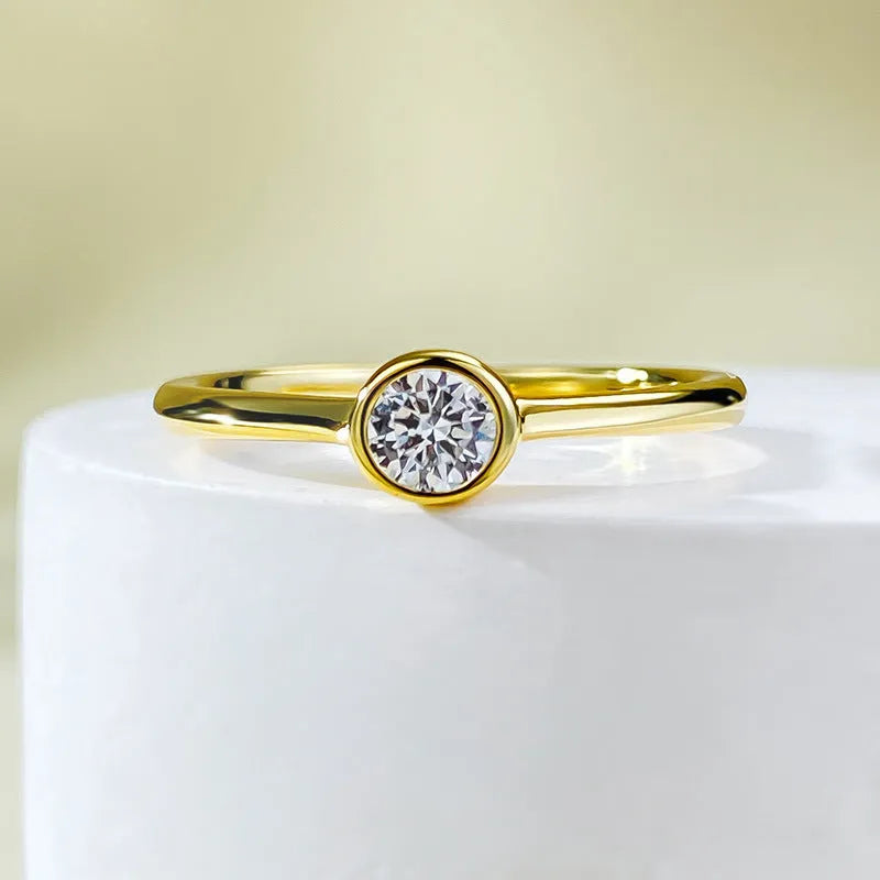 Minimalist crown-shaped silver ring in gold or platinum finish, shown in a simple setting.