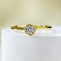 Minimalist crown-shaped silver ring in gold or platinum finish, shown in a simple setting.