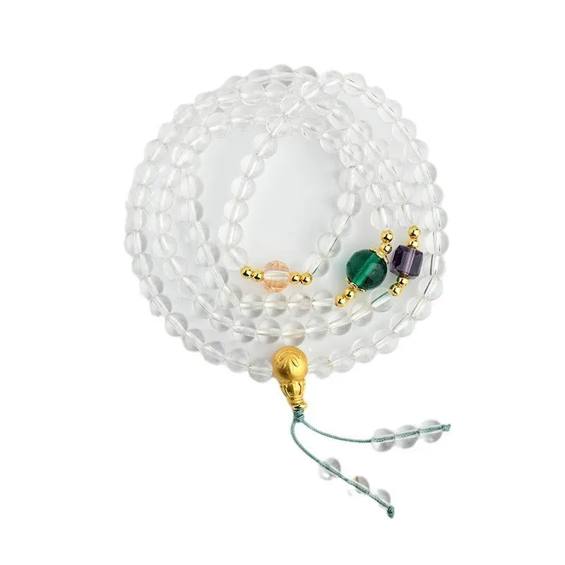 White crystal 108-bead rosary necklace and matching bracelet set on a plain background