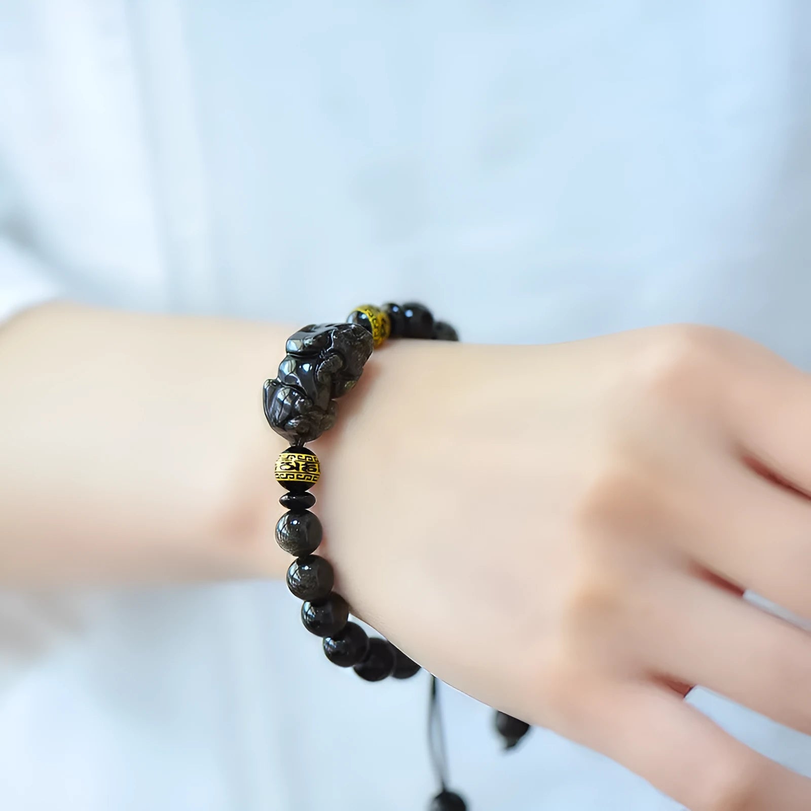 Hand-woven golden obsidian Pi Xiu bracelet with zodiac design in multiple bead sizes