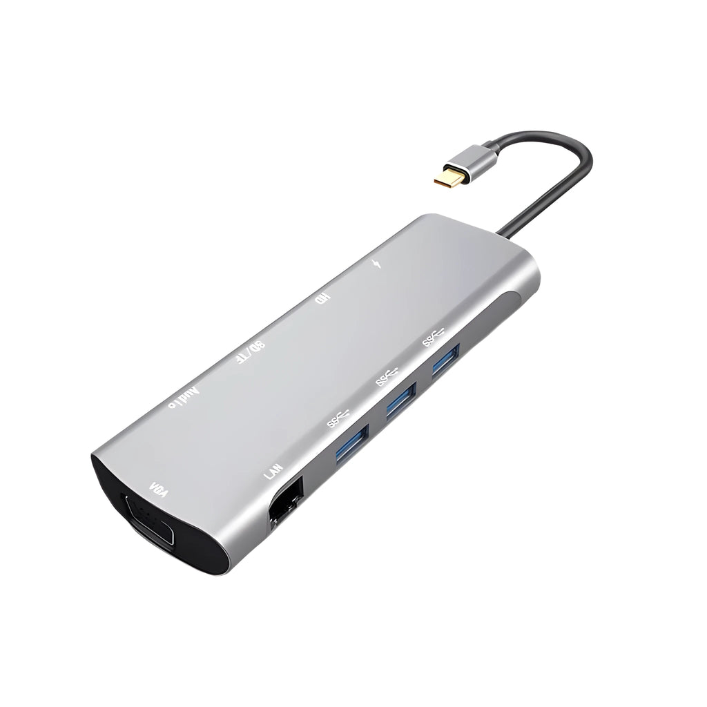 Grey aluminium USB-C docking station with HDMI, VGA, USB 3.0, and PD charging ports on a desk.