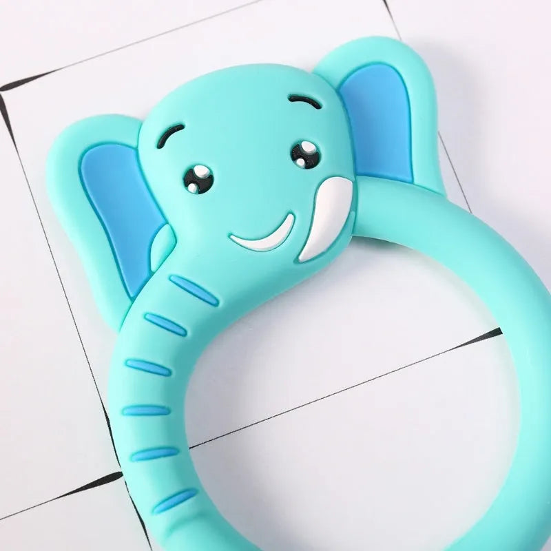 Three silicone baby molar teethers in brown, blue, and yellow on a white background