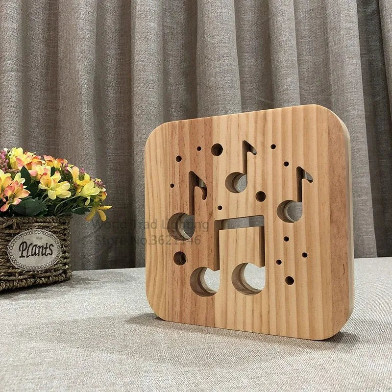 Square pine wood USB LED lamp emitting warm white light on a wooden surface.