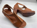 Women's low heel peep toe wedge sandals with a Roman style buckle strap in light brown.