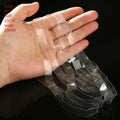 Transparent white TPU rubber bands in multiple sizes on a white background