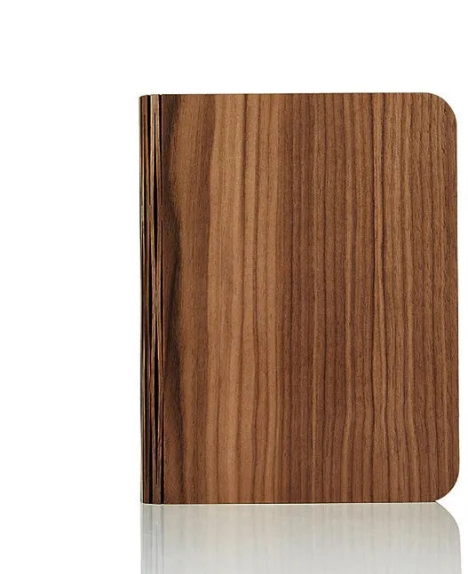 Solid wood USB-powered book light in three sizes on a desk with a book.