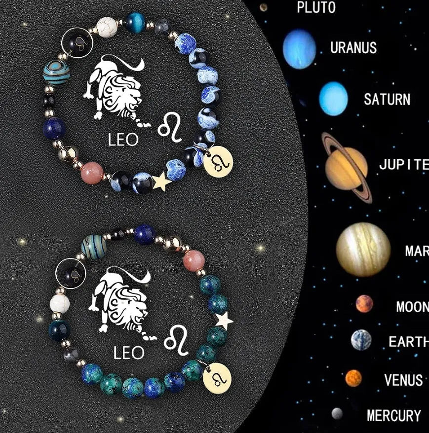 Two natural stone beaded bracelets with sterling silver zodiac charms on a wooden surface.