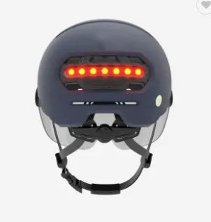 Cycling helmet with built-in red LED tail and brake lights on the rear, shown in M and L sizes.