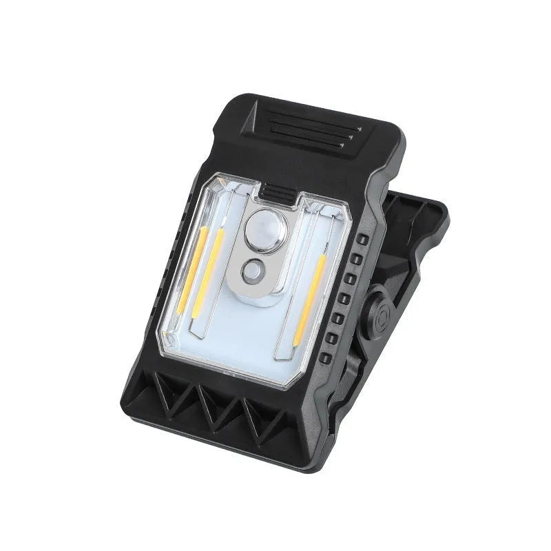 Compact white ABS plastic LED clip lamp with motion sensor, shown clipped to a shelf edge.