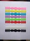 Pack of eight coloured silicone tool buckle straps on a workbench