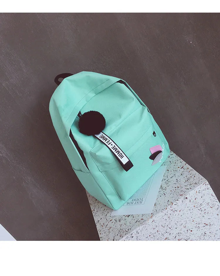 College style canvas backpack in green with leaf pattern, showing 40cm height and organisational compartments
