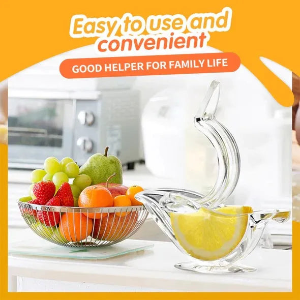 Transparent acrylic bird-shaped manual juicer for lemon slices on a kitchen counter.