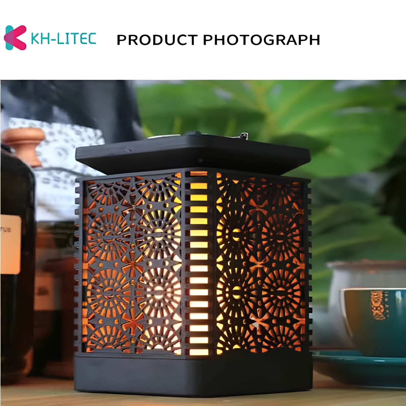Set of four black solar-powered garden lanterns with flickering flame LED lights.