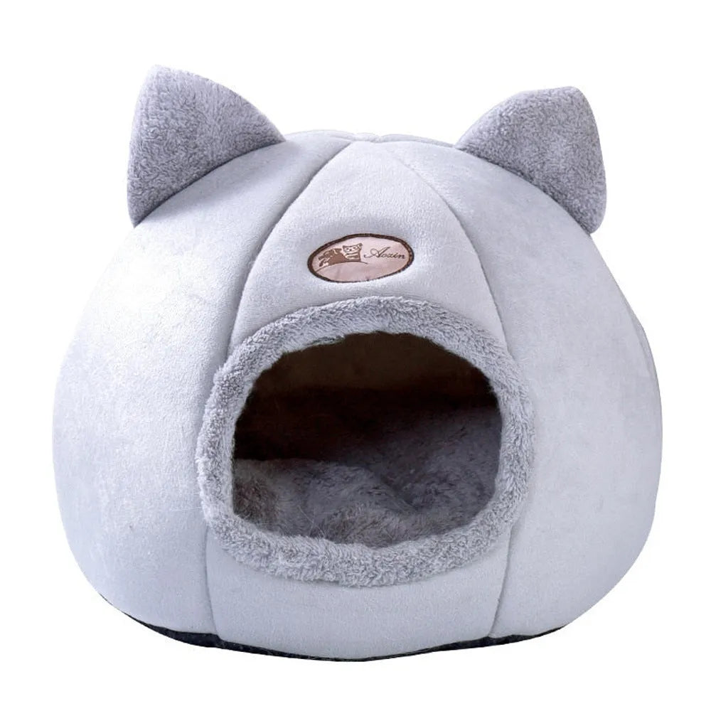 Grey enclosed cat sofa bed with a round entrance hole, showing a soft plush interior and removable cushion.