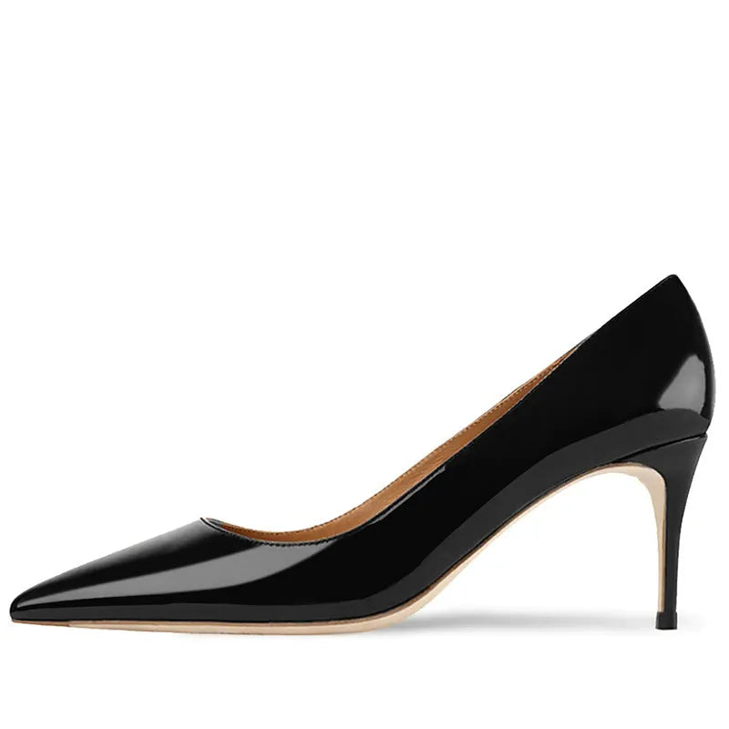 Women's black pointed toe high heel shoes with soft rubber sole on wooden surface