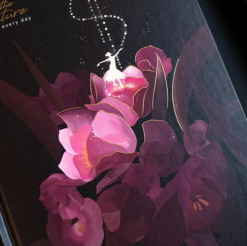 A5 notebook with luminous cover open to show pages filled with colour illustrations.