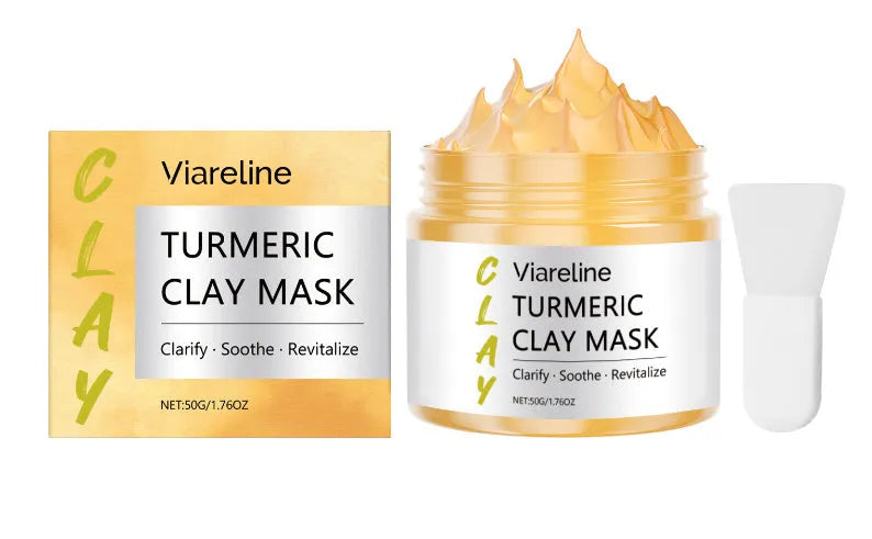 Yellow turmeric mud mask in a tub with an application brush.