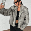 Women's short black and white artificial fur coat with a large fur collar, shown in a cute style pose.