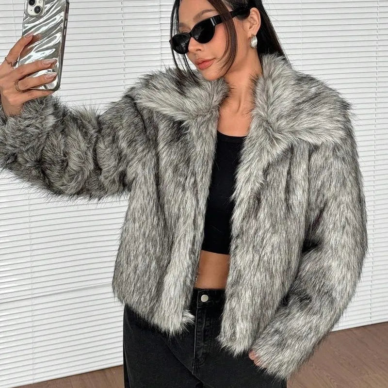Women's short black and white artificial fur coat with a large fur collar, shown in a cute style pose.