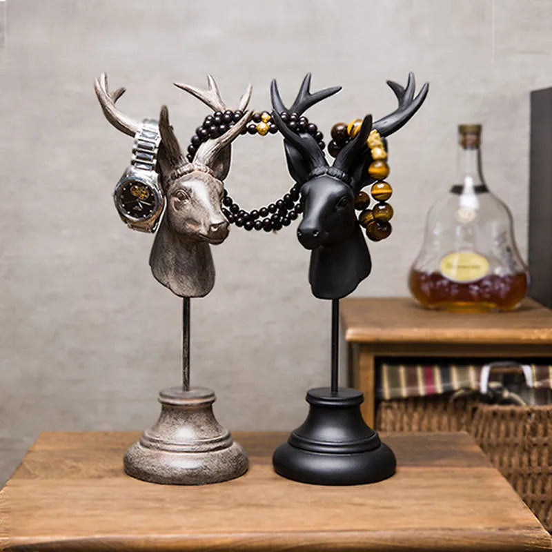 A tall black animal-shaped decorative ornament made from natural resin on a wooden shelf.