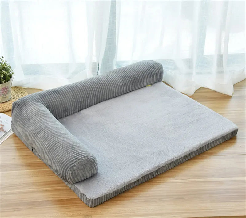 Corduroy pet dog sofa with bolster sides on a non-slip cloth base, shown in grey colour.