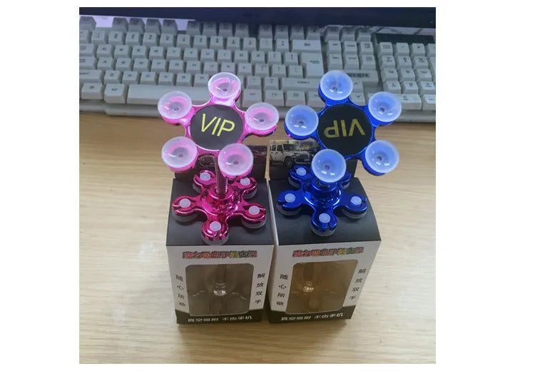 Double-sided silicone suction phone holder in silver-white on a desk, measuring 8x5.5cm