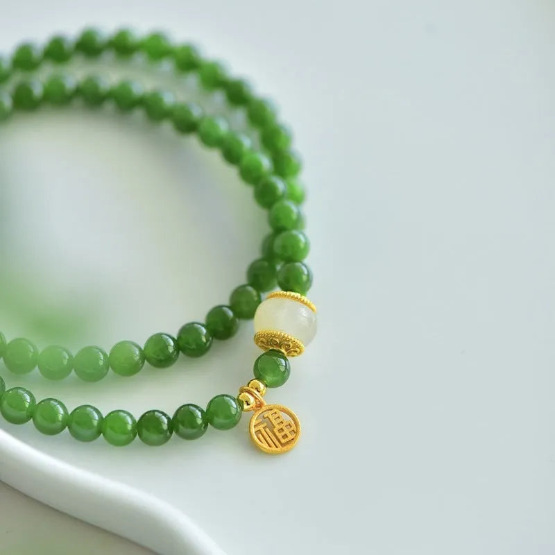 Women's double circle bracelet made from natural Hetian Jade, showing geometric shape and fu character detail.