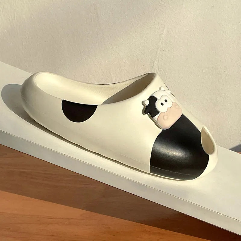 Thick-soled cartoon cow print EVA flip flops in black and white