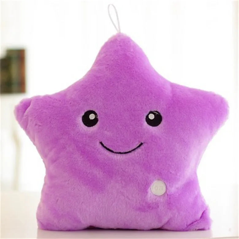 Colourful glowing five-pointed star plush pillow on a dark background, showing soft texture and LED illumination