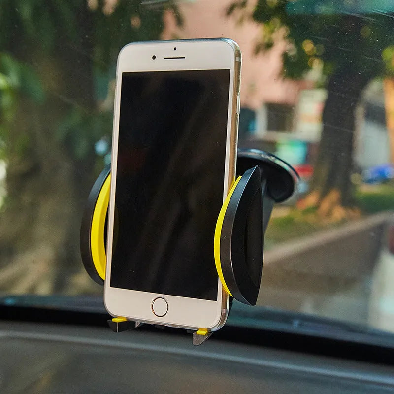 Blue suction cup U-shaped car phone holder mounted on a dashboard holding a mobile phone.
