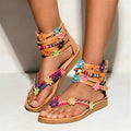 Women's ethnic beaded petal Roman sandals with floral decoration on artificial PU upper.