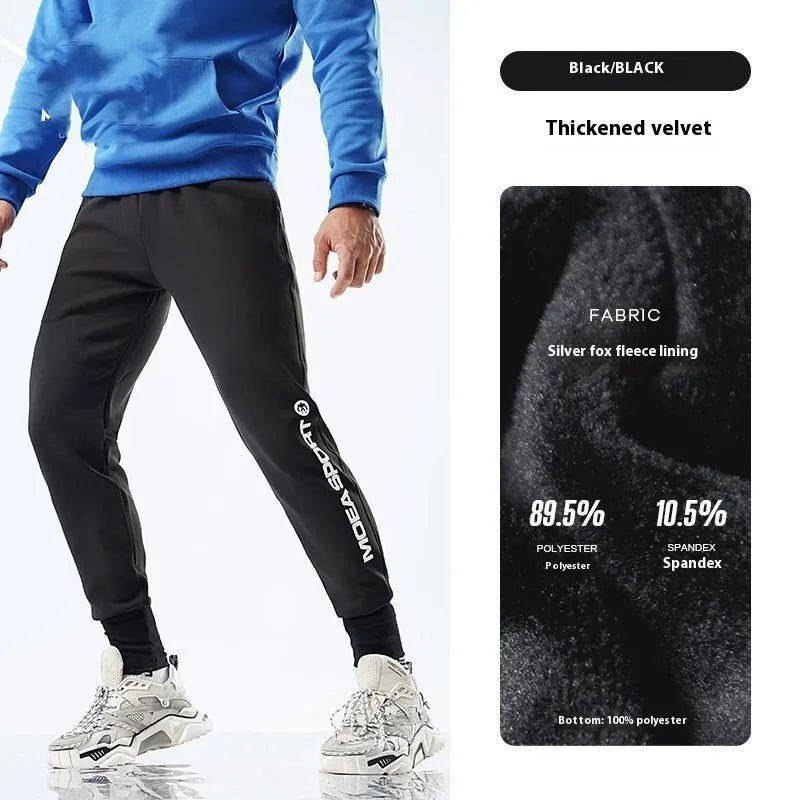 Men's grey blue sweatpants with ankle ties laid flat, showing mid-waist and tapered leg design.