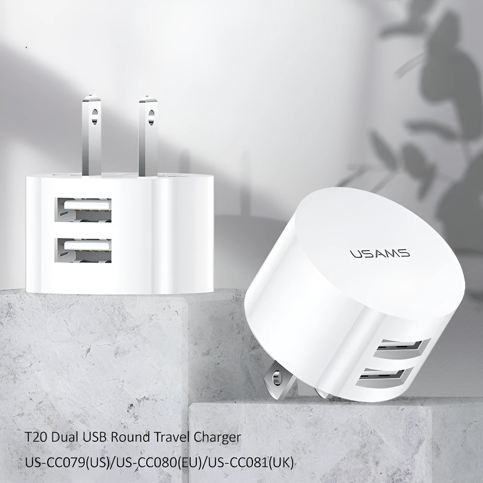 White portable universal dual USB phone charger with foldable US, EU, and UK plugs showing 39mm diameter