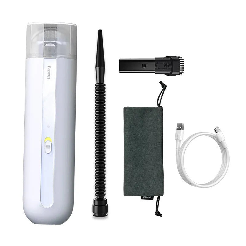 Starry sky black handheld cordless car vacuum cleaner with blowing hose accessory on a desktop.