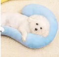 Blue and yellow question mark shaped cat bed with a built-in U-shaped neck support pillow on a wooden floor.