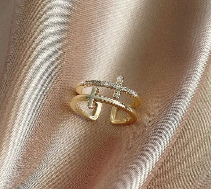 Women's adjustable copper ring with double cross design and white zircon stone in sterling silver inlay.