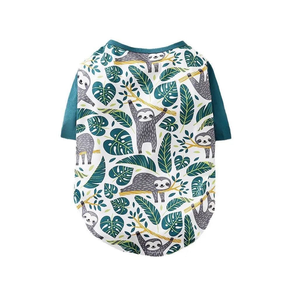 Casual printed polyester T-shirt for a small dog on a green background, showing the colourful design.