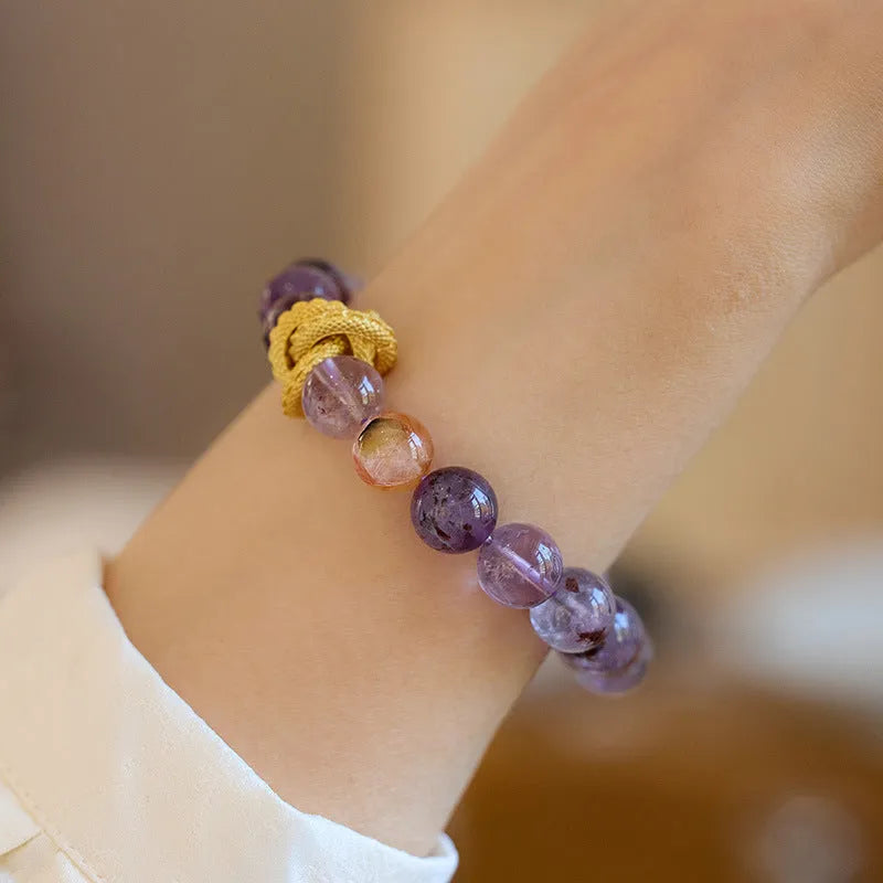 Purple cornucopia crystal bracelet with 10mm animal zodiac beads on wrist