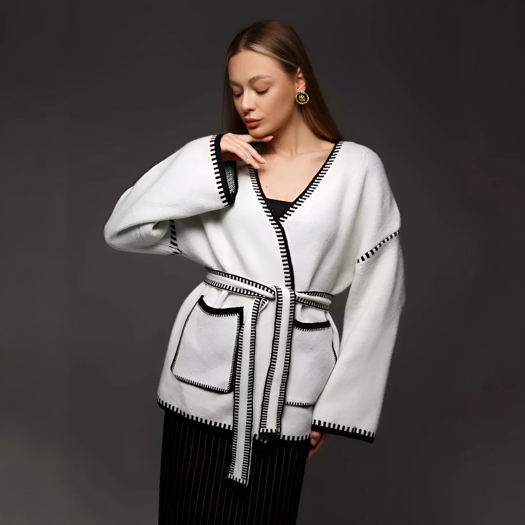 Loose lace-up knitted cardigan in camel colour, showing mid-length fit and long sleeves.