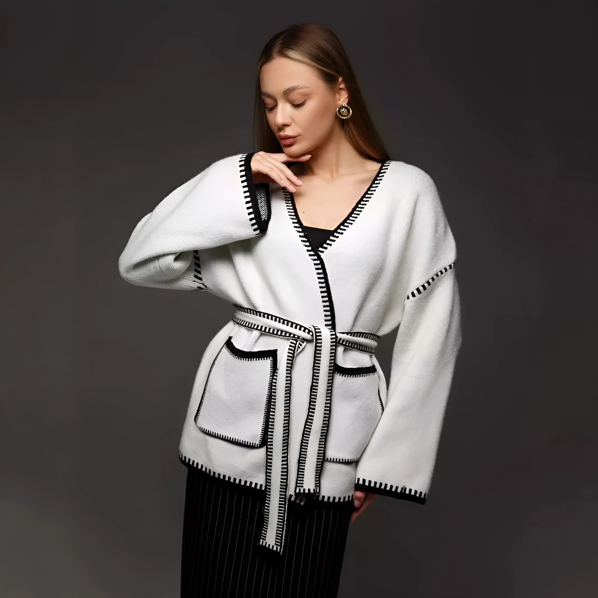 Loose lace-up knitted cardigan in camel colour, showing mid-length fit and long sleeves.