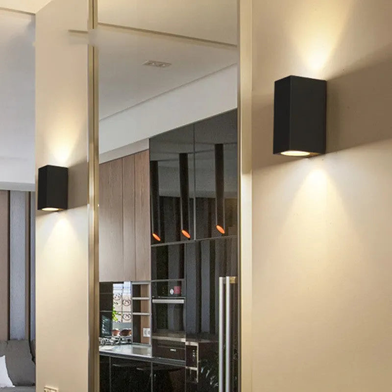Modern black aluminium LED wall lamp with glass shade and silicone rubber trim.