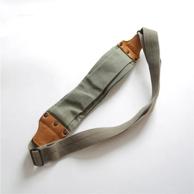 Green American retro military style chest bag with washed canvas and cowhide leather details